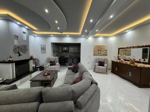 a large living room with a couch and a table at Luxury apartment in Amarynthos