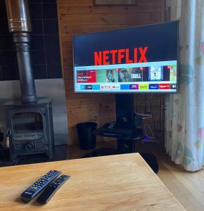 a television with a netflix sign on a table at Buzzard Lodge with Hot-tub in Carlisle