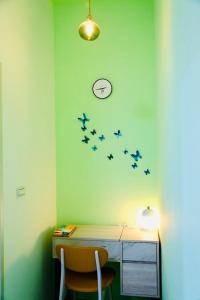 a room with a desk with a group of planes on the wall at 澎湖卡米諾名宿 in Magong