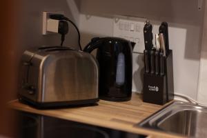 a kitchen counter with a toaster next to a sink at Central Retreat- A Cosy 2 Bedroom Flat with View in L3 in Liverpool