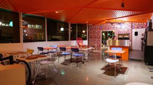 a restaurant with tables and chairs in a room at HYP'Hotel in Saint-Marcellin