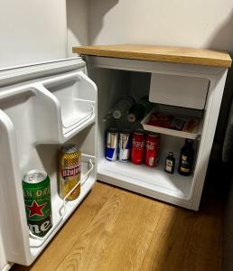 an open refrigerator filled with drinks and condiments at RoomS in Slavonski Brod