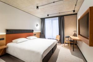 Postel nebo postele na pokoji v ubytování Qubus Hotel Katowice
