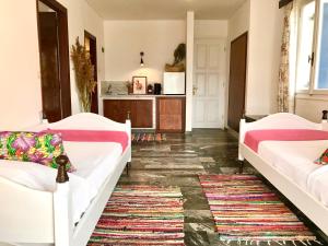 a living room with two beds and a kitchen at Theodora Hotel in Petra