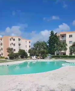 a swimming pool in front of some apartment buildings at Serena 4 in Punta Cana