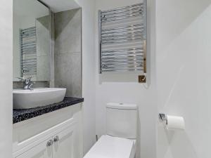 a white bathroom with a sink and a toilet at 1 Bed in Matlock 85176 in Matlock