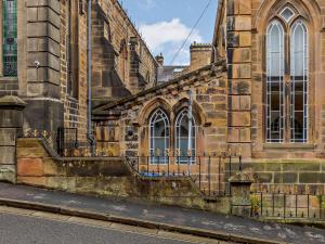 an old stone building with a staircase on the side of it at 1 Bed in Matlock 85176 in Matlock