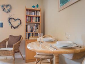 a dining room with a table and chairs and a book shelf at 1 Bed in Matterdale SZ222 in Watermillock