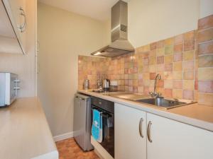 a kitchen with a sink and a stove at 1 Bed in Matterdale SZ222 in Watermillock