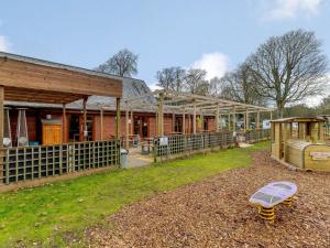 a barn with a building and a playground at 2 Bed in Dunwich 85185 in Westleton
