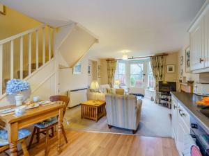 a kitchen and a living room with a table at 1 bed property in Keswick 86117 in Braithwaite