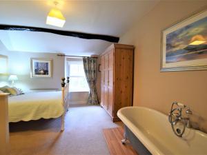 a bathroom with a bed and a bath tub in a room at 1 bed property in Keswick 86117 in Braithwaite