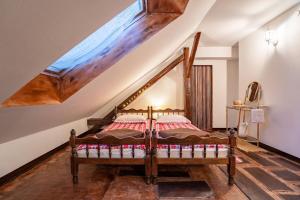 ein Schlafzimmer mit einem Holzbett im Dachgeschoss in der Unterkunft Kuća za odmor Treasure Hunters Academy in Bjelovar