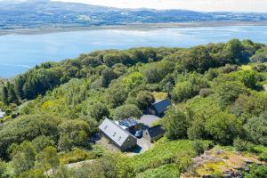 an aerial view of a house on a hill next to a lake at 3 Bed in Aberdovey DY033 in Aberdyfi