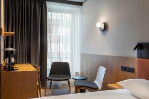 Postel nebo postele na pokoji v ubytování Qubus Hotel Katowice