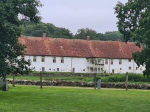 a large white building with a red roof at Bysmedjan in Hässleholm