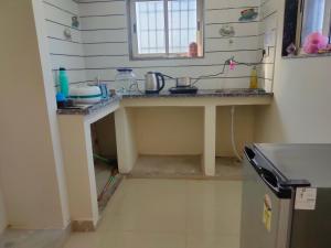 a kitchen with a sink and a counter top at My Nest - Best Homestay for Peaceful Stay with Comfort in Bhuj