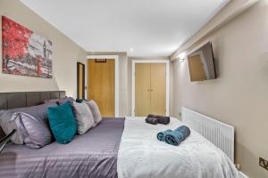 sypialnia z dużym łóżkiem z niebieskimi poduszkami w obiekcie Tranquil Apartment Southwark w Londynie