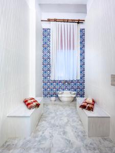 a bathroom with two benches in front of a window at Historical Apt. with Galata Sea View/Turkish Hamam in Istanbul