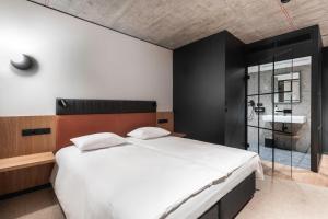 a bedroom with a large bed and a sink at Qubus Hotel Katowice in Katowice
