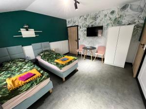 a bedroom with two beds and a table and chairs at Pokoje Gościnne "Cyprian" in Siedlce