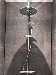 a shower stall with a shower head with a light at All-in Penthouseroom in Amsterdam