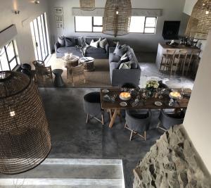 a living room with a couch and a table at Barefoot Addo Elephant Lodge - Luxury Family Villa in Addo