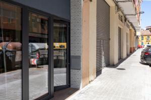 a store front with glass doors on a street at Apartamento Acogedor céntrico MJ in Valencia