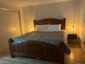 a bedroom with a large wooden bed with two lamps at Private Lake House in Puyallup