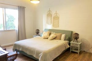 a bedroom with a large bed and a window at Lovely 2 Bedroom in Gemmayze in Beirut