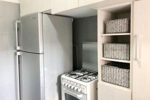 a white kitchen with a stove and a refrigerator at Lovely 2 Bedroom in Gemmayze in Beirut +16 photos