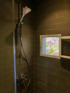 a shower in a bathroom with a television in it at Lovely 2 Bedroom in Gemmayze in Beirut