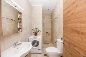 a bathroom with a washing machine and a sink at Contessa Caterina in Karousádes