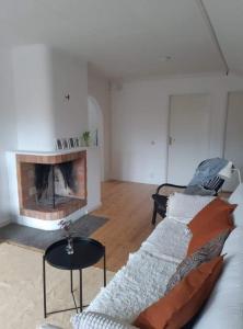 a living room with a couch and a fireplace at Bograngen LGH D in Brograngen