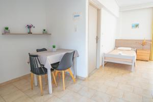 a dining room with a table and chairs at Anthia Apartments in Marmari