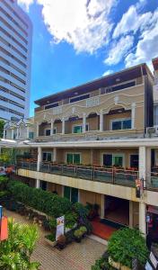 a large building with a balcony in front of it at Sawasdee Apartment Patong in Patong Beach