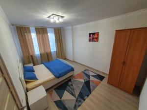 a small bedroom with a bed and a window at 2-ух комнатная квартира Юнис Сити г.Актобе in Aktobe