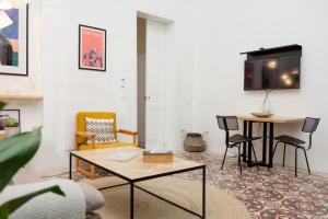 a living room with a table and a tv at Hidden Gem 1BR Apartment in Beirut