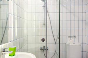 a bathroom with a shower with a toilet and a sink at Hidden Gem 1BR Apartment in Beirut