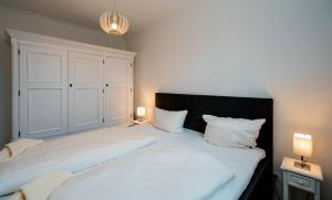 a bedroom with a large bed with two white pillows at Heike in Westerland (Sylt)