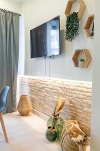 Et tv og/eller underholdning på Apartamento con piscina y terraza