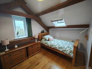 a bedroom with a bed and a window at Ty Gwennol near Gilfach Goch in Llanbedr