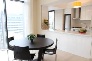a kitchen and dining room with a table and chairs at Modern 3 Bed 3 Bath Apt w Sea View in Beirut