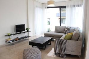 a living room with a couch and a coffee table at Modern 3 Bed 3 Bath Apt w Sea View in Beirut