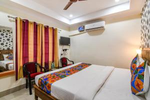 a hotel room with a bed and a bedroom at FabHotel Sagar Royale in Bhubaneshwar