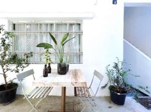 einen Tisch und Stühle in einem Zimmer mit Pflanzen in der Unterkunft Cozy Studio w Yard and Rooftop in Badawi in Beirut