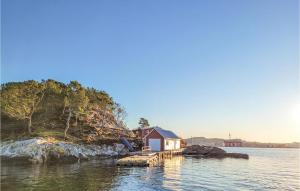 a small house on a small island in the water at Stunning Home In gotnes With Kitchen in Ågotnes