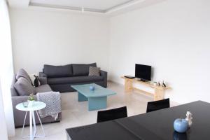 a living room with a couch and a table at Modern 3BR Apt next to Hotel Dieu in Beirut