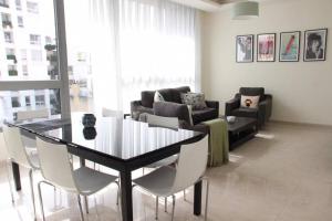 a living room with a table and a couch at Modern 3BR Apt next to Hotel Dieu in Beirut