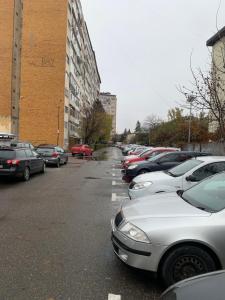 a row of parked cars in a parking lot at Page3 Apartament in Târgovişte